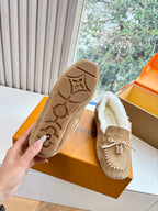 Unisex taupe suede loafers showing molded rubber sole with shearling trim
