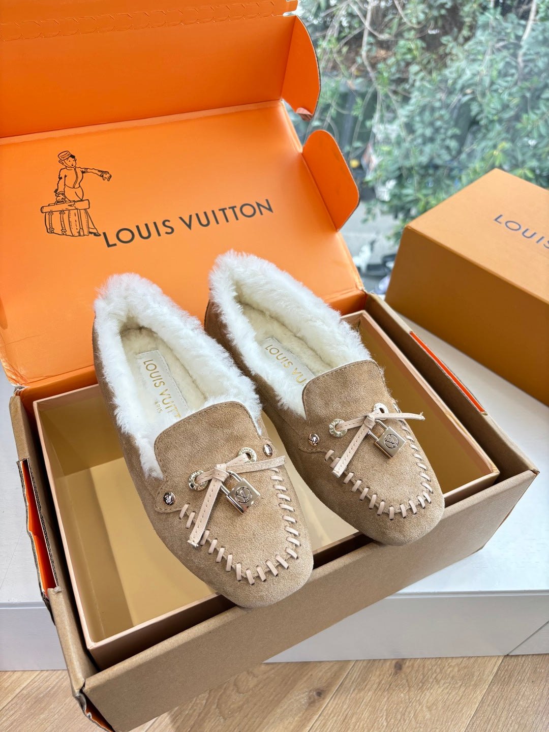 Unisex taupe suede loafers with white shearling lining and bow-tie detail