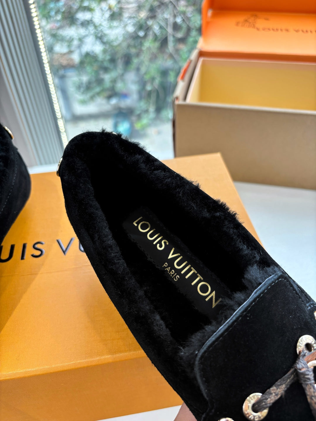 Black suede loafer with Louis Vuitton logo on insole, silver-tone lace detail.
