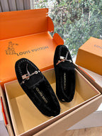 Pair of black suede loafers with silver rope laces and LV logo charm