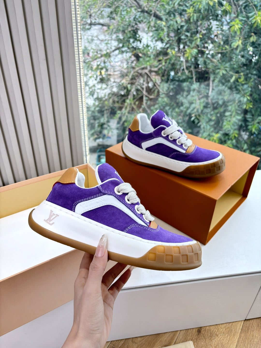 Purple Louis Vuitton low-top sneakers with white midsole, gum outsole, white lace-up