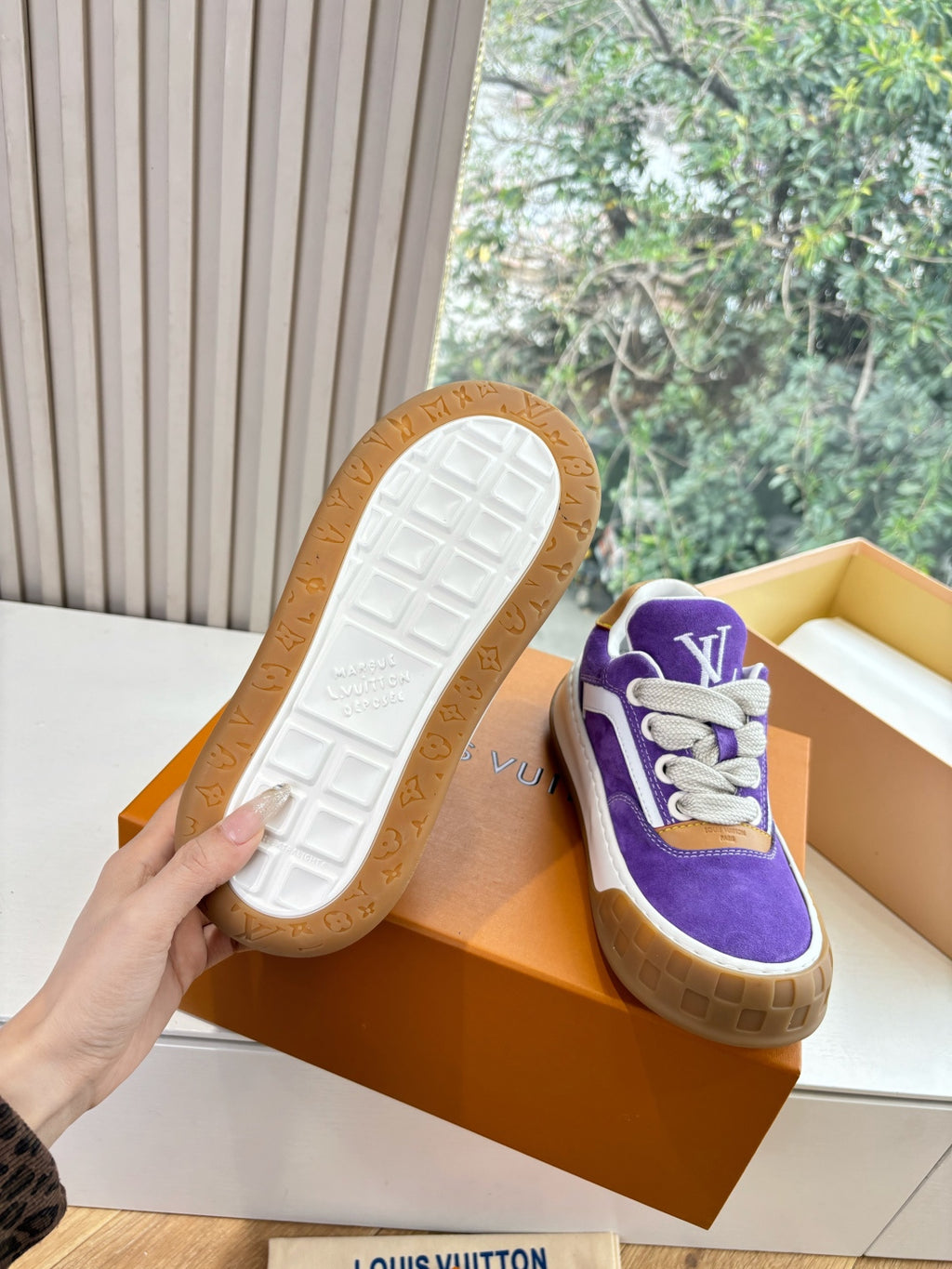 Louis Vuitton sneakers with visible tread outsole; white sole with embossed pattern