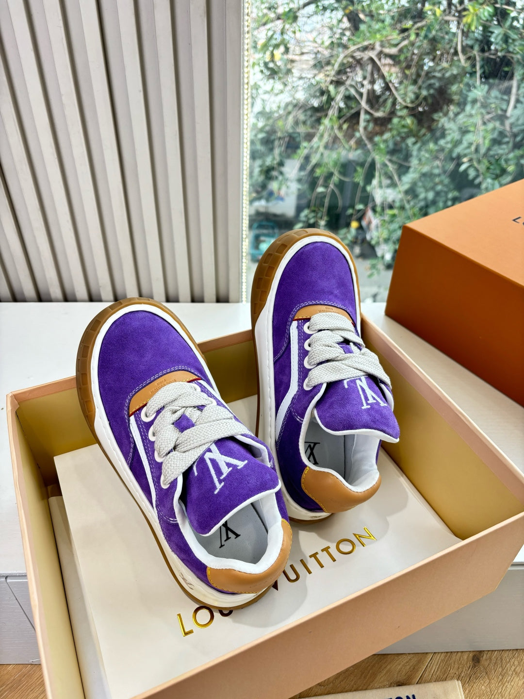 Louis Vuitton unisex purple sneakers with LV logos, white laces, brown heel accents