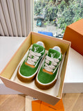 Green suede sneaker with white laces, tan rubber sole, LV logo detail in box