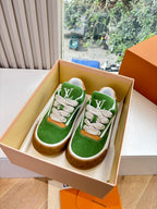 Green suede sneaker with white laces, tan rubber sole, LV logo detail in box