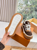 Brown and white sneaker with gum rubber outsole and textured tread