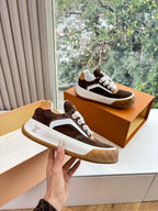 Brown and white low-top sneakers with white laces and gum rubber sole