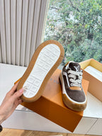 Brown suede sneakers with white outsole sole grid, LV-style branding on side, gum sole.