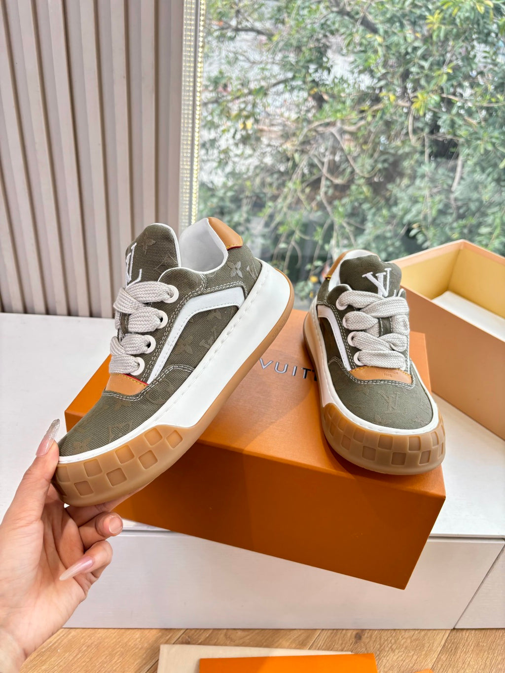 Louis Vuitton low-top sneakers, dark olive with white laces, orange trim and white side panels