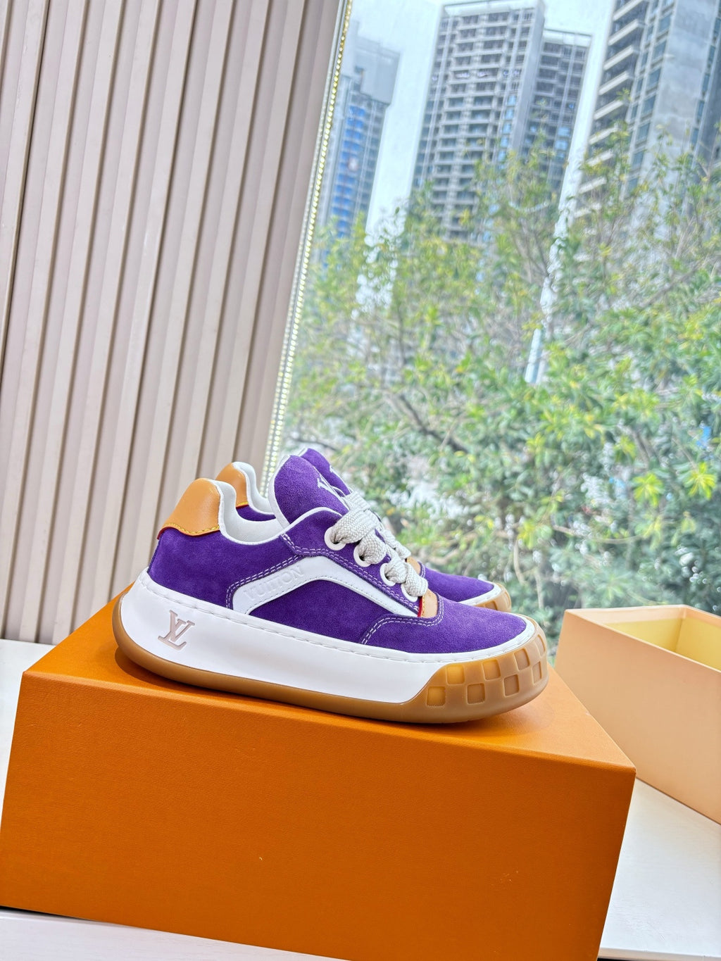 Purple Louis Vuitton low-top sneakers with white midsole, gum sole, white lace-up