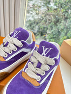 Close-up of Louis Vuitton purple sneakers showing LV logos on tongue and side