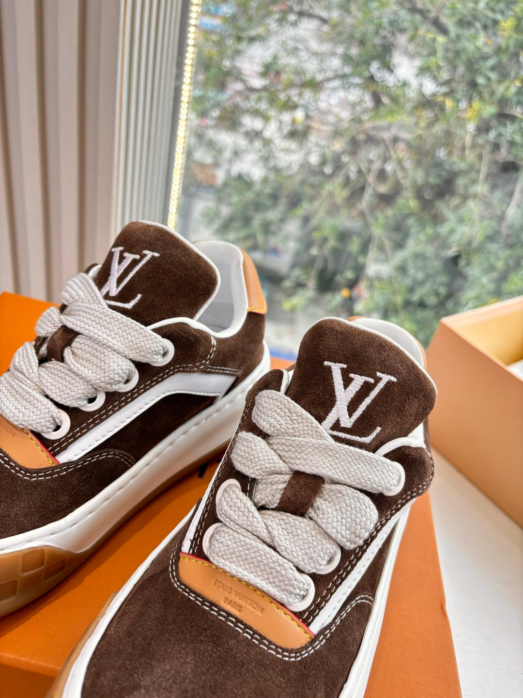 Brown suede low-top sneakers with white laces and LV monogram on tongue