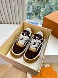 Brown suede sneakers with white laces and LV side emblem, shown in an open box.