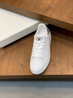 White leather sneaker with lace-up closure and patterned lining detail at collar