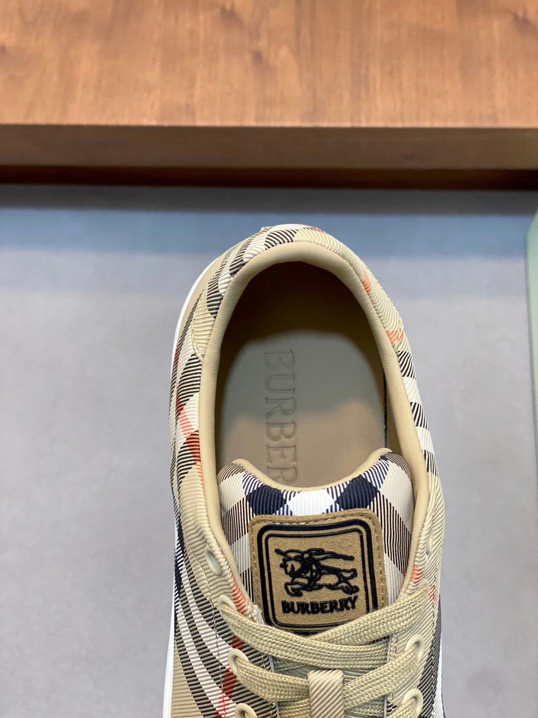 Burberry check sneakers, close-up of tongue patch and lace-up front