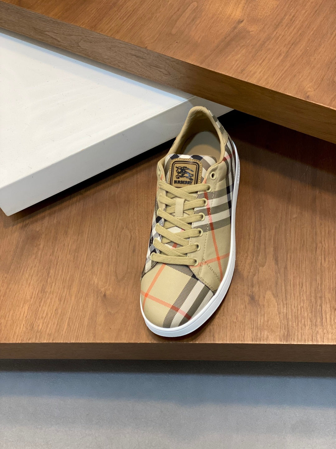 Burberry check low-top sneakers, single shoe on shelf, beige plaid lace-up