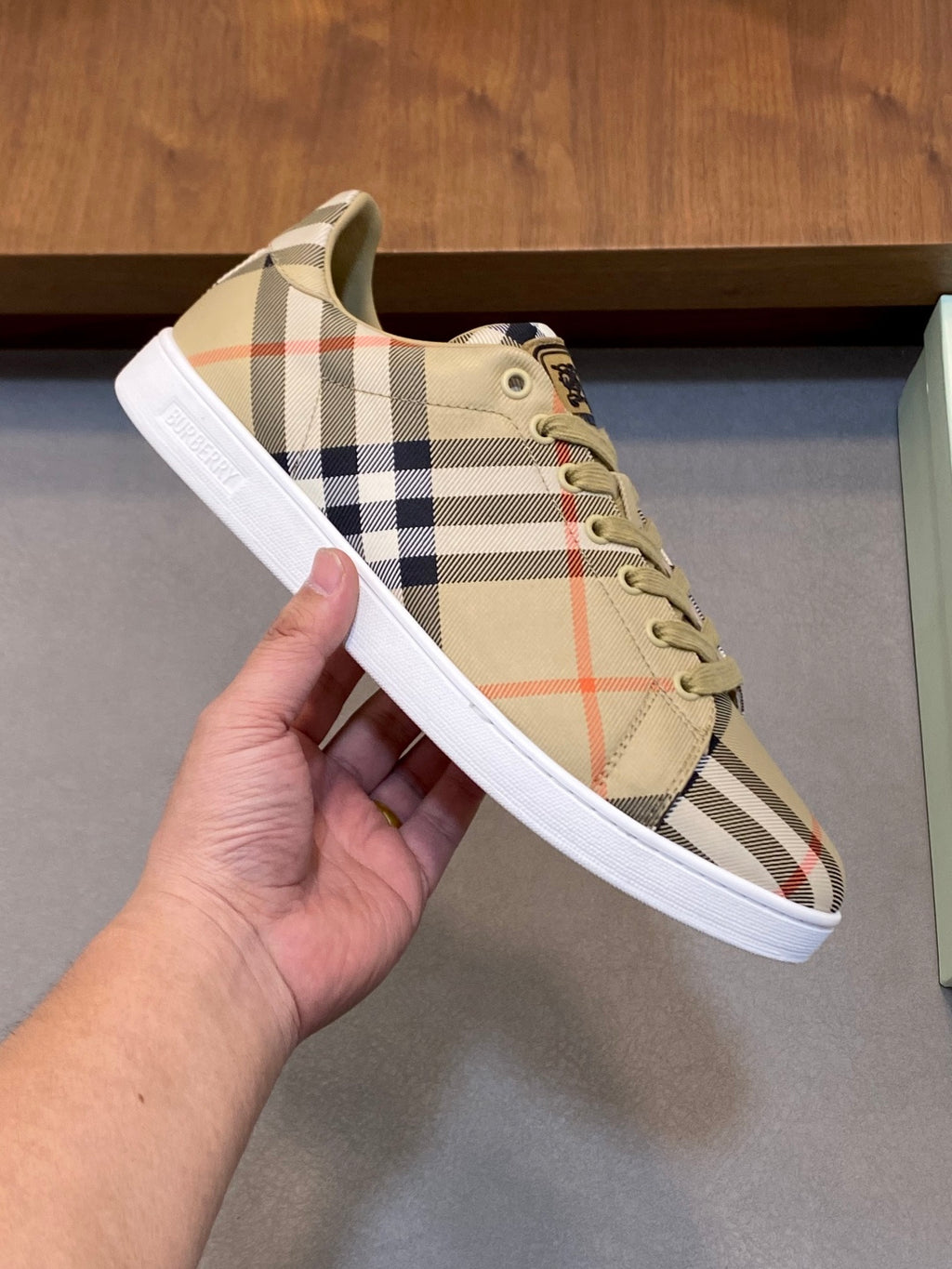 Burberry check low-top sneakers, hand-held close-up, beige plaid lace-up