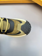 Moncler sneaker close-up of rubber outsole tread on olive and black upper