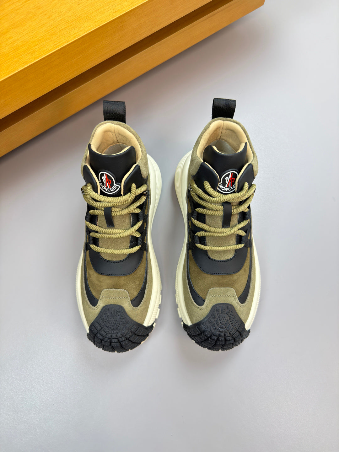 Moncler sneakers, top view: olive suede panels, black accents, neon-yellow laces
