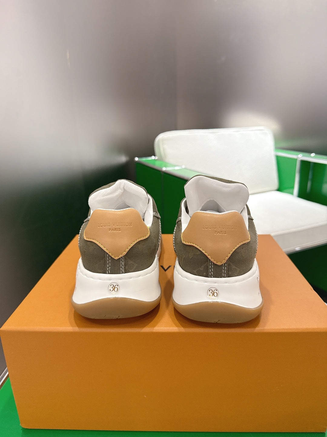 Unisex sneakers heel view in white and olive with tan back tabs and size 36