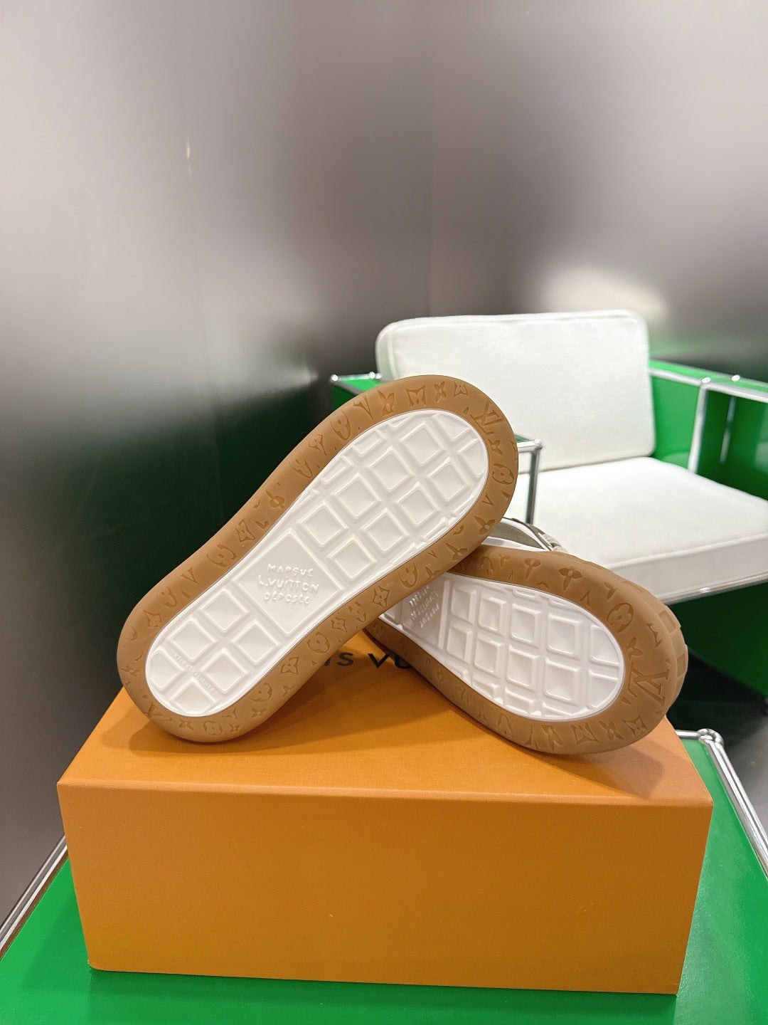 Unisex sneaker outsoles with white tread pattern and tan rubber edges