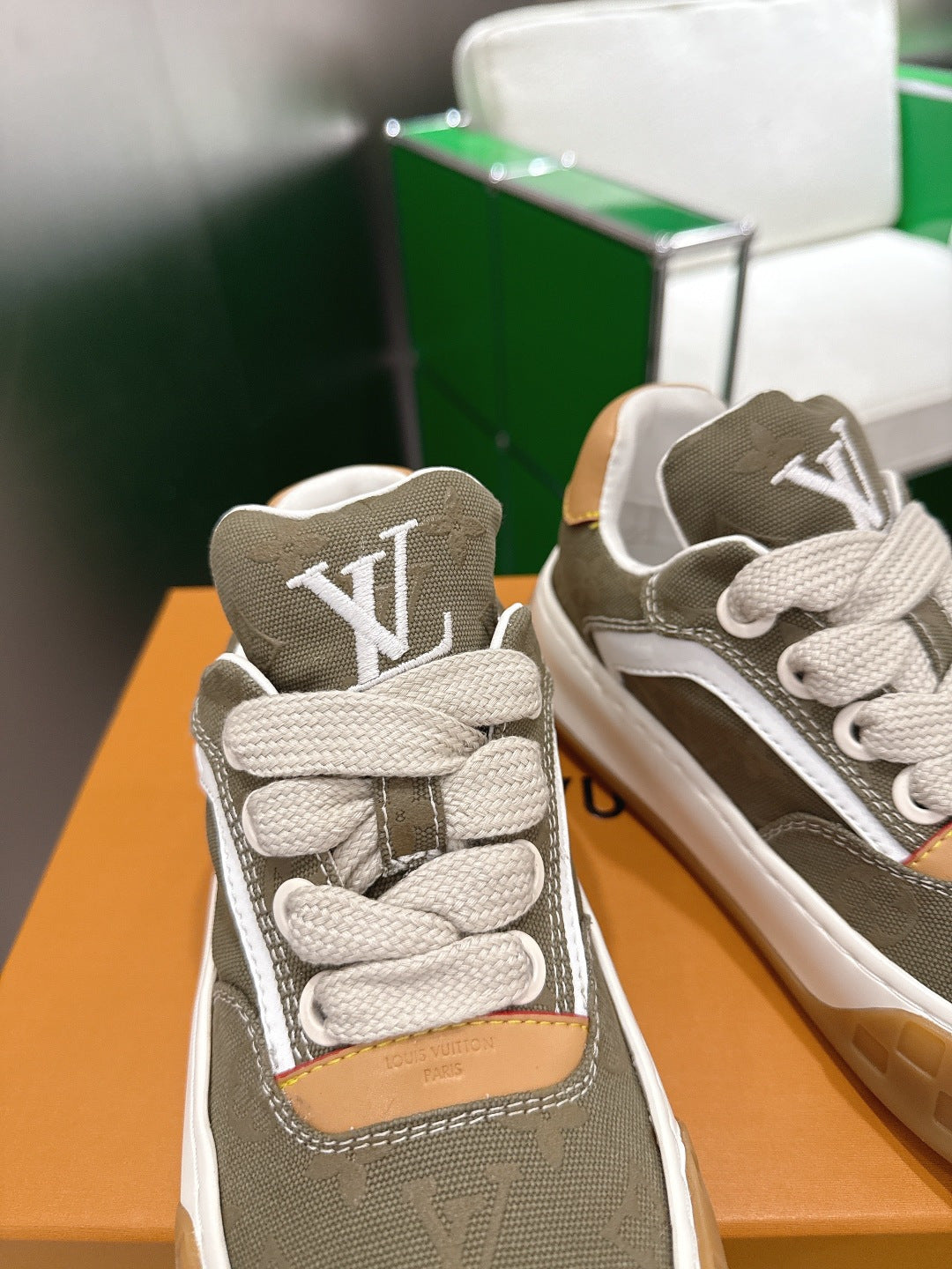 Unisex sneakers close-up with LV monogram on olive canvas and tan ankle patch