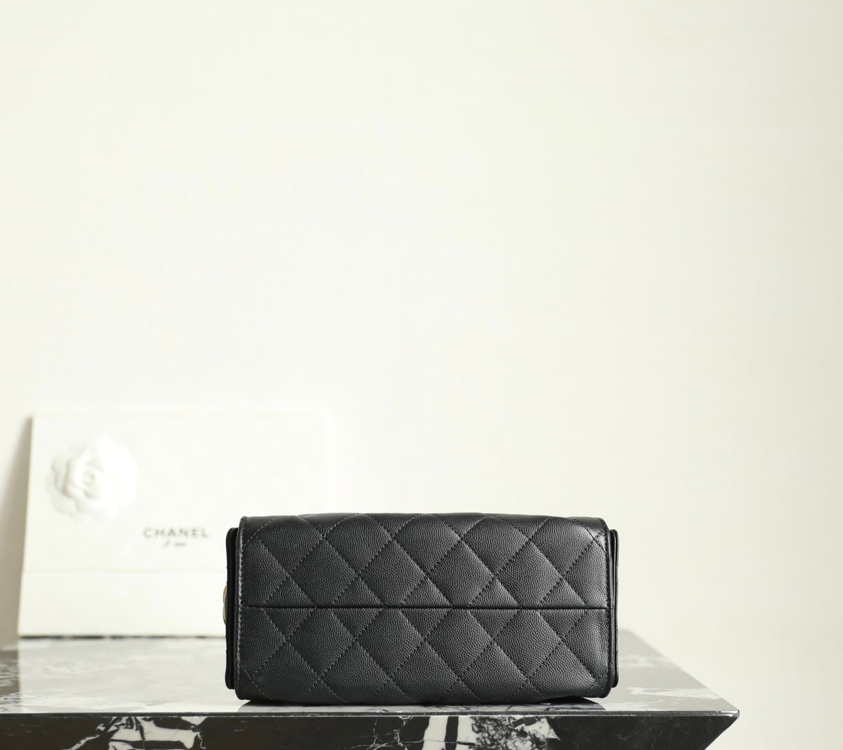 Chanel black quilted leather flap clutch-style bag with stitched diamond pattern