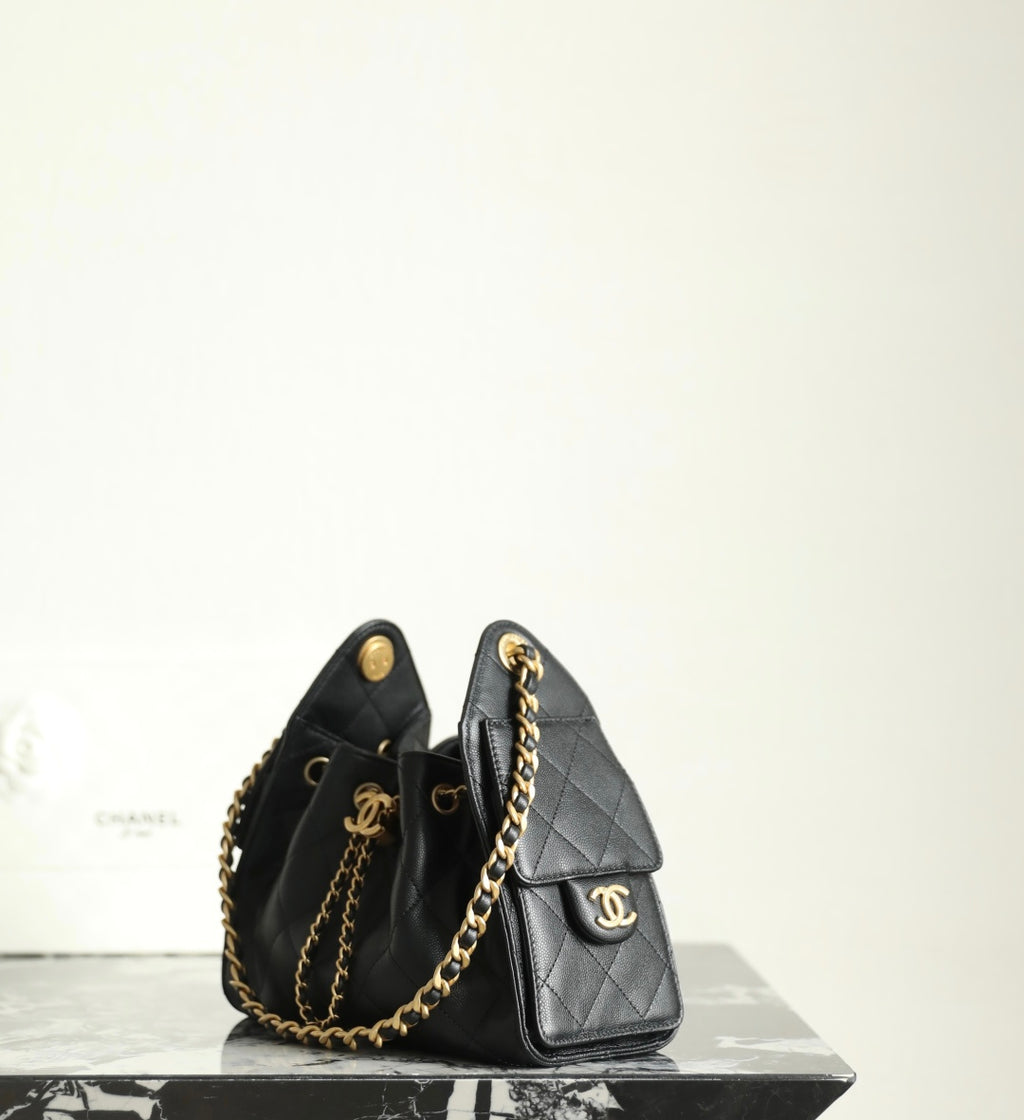 Chanel black leather mini bucket bag with gold chain strap and front logo emblem