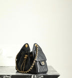 Chanel black leather mini bucket bag with gold chain strap and front logo emblem