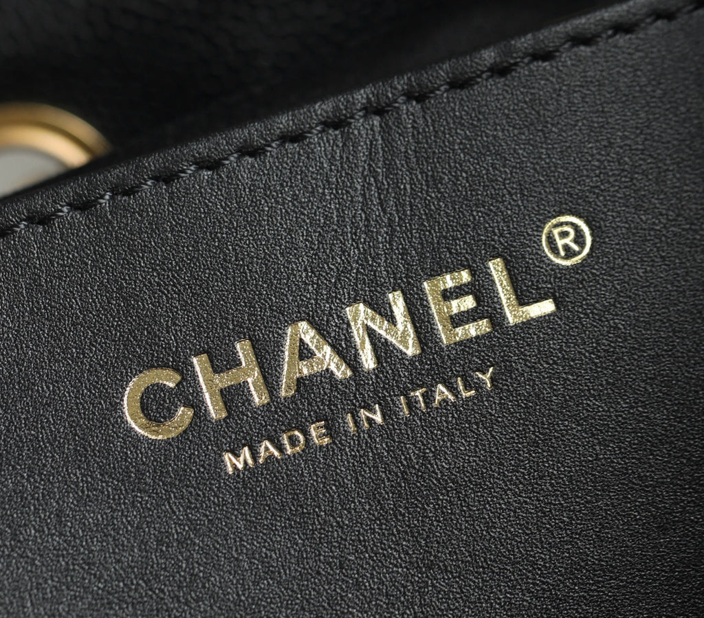 Chanel logo embossing on black leather with decorative stitch detail
