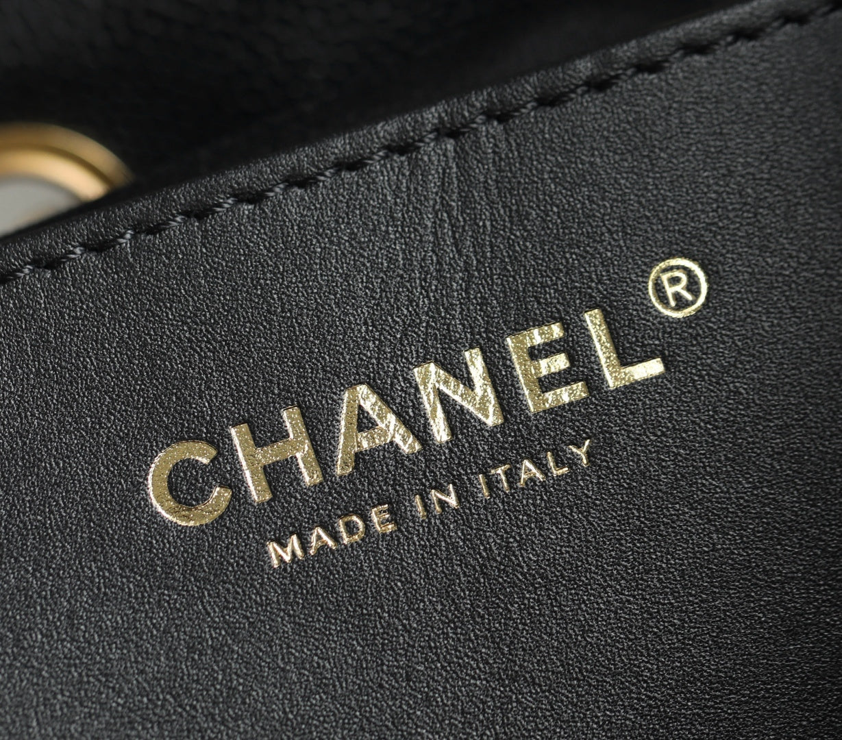 Chanel logo embossing on black leather with decorative stitch detail