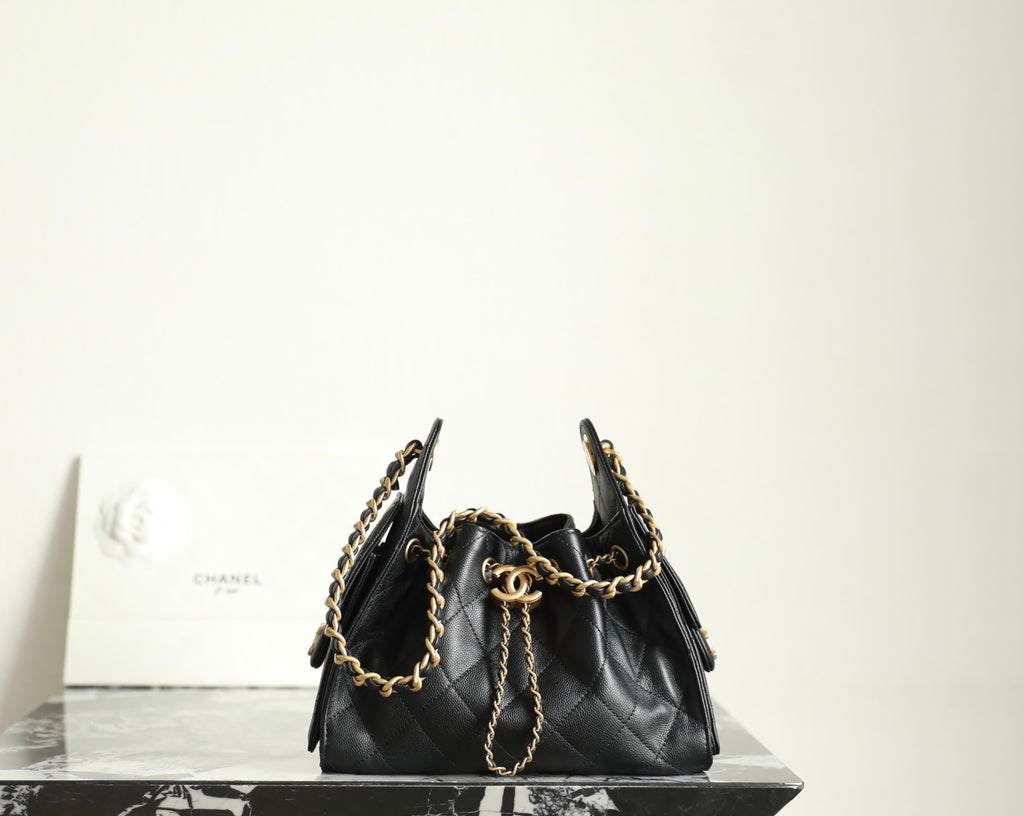 Chanel black leather bucket bag with gold chain shoulder straps and drawstring top