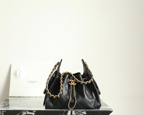 Chanel black leather bucket bag with gold chain shoulder straps and drawstring top