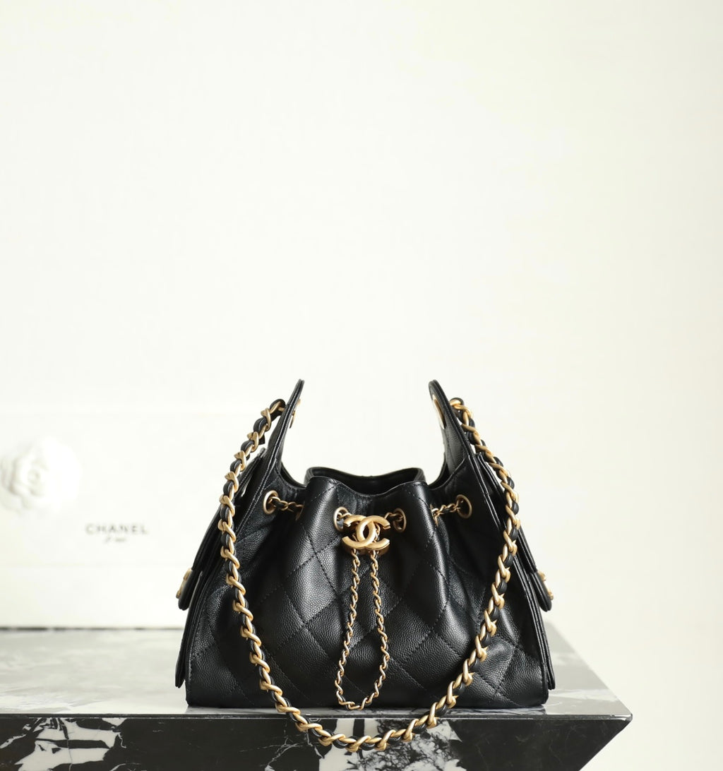 Chanel black leather bucket bag with gold chain shoulder strap and logo charm ring