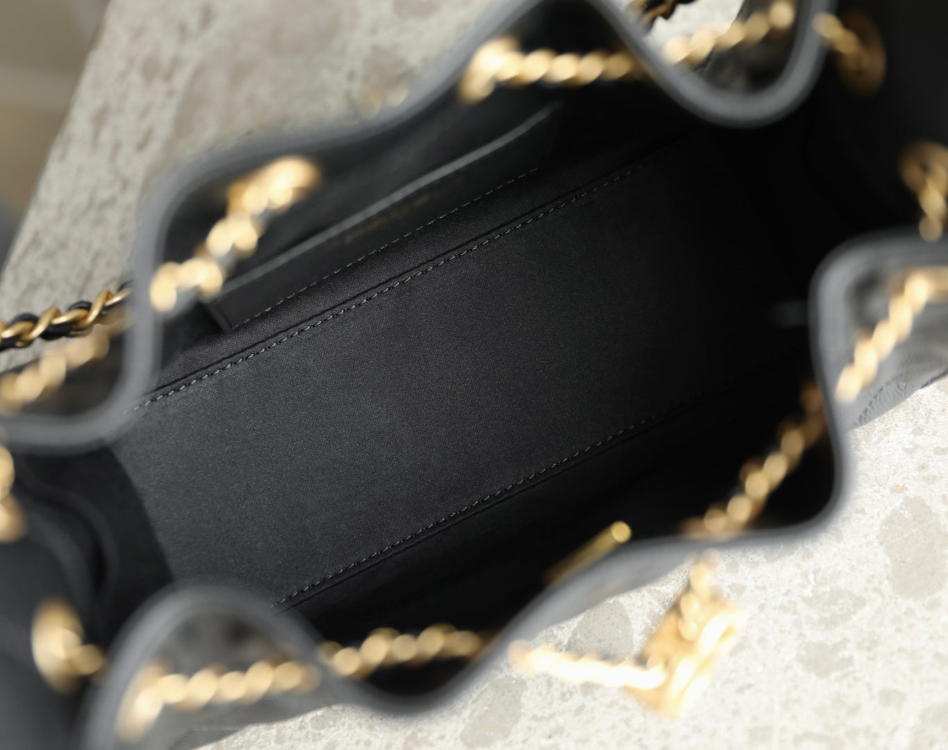 Chanel black leather bag interior and top edge with gold chain strap
