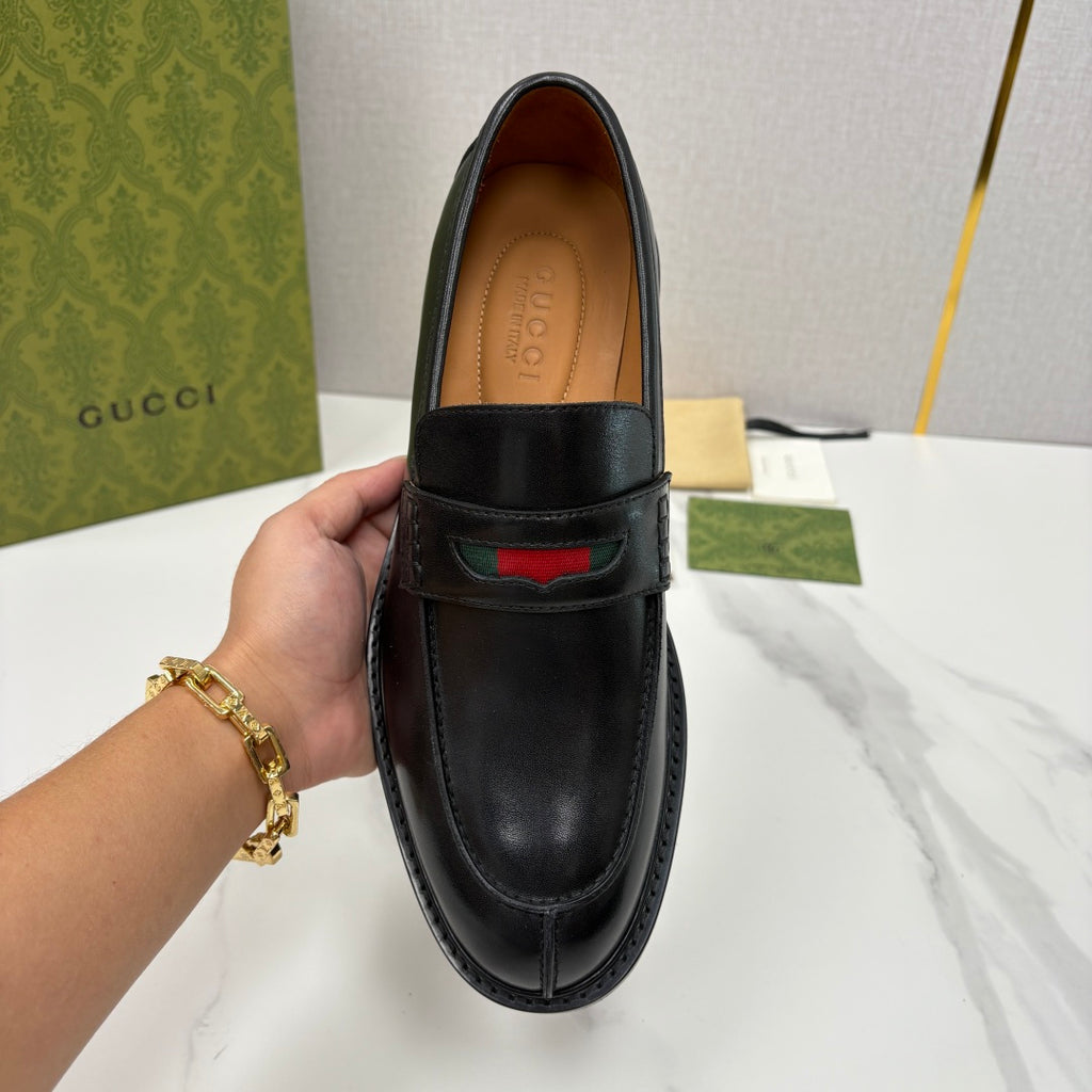 Gucci black leather loafer front view with red green stripe detail