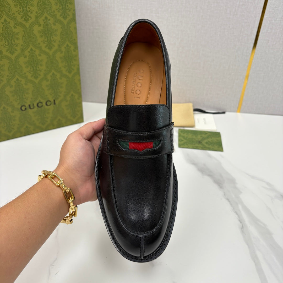 Gucci black leather loafer front view with red green stripe detail