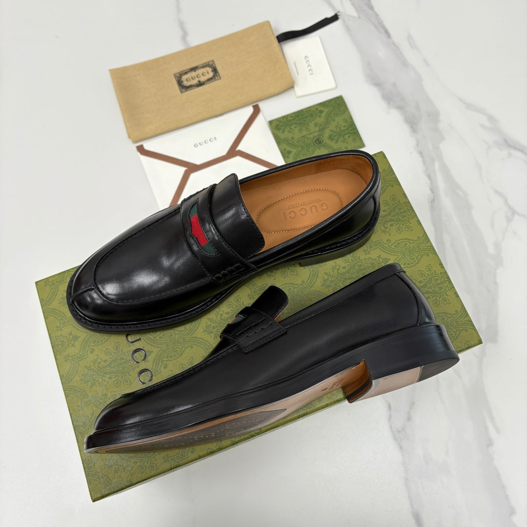 Gucci black leather slip-on loafers with red green striped band across vamp