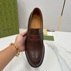 Gucci unisex leather loafer front view, dark brown with green-red stripe across moc toe