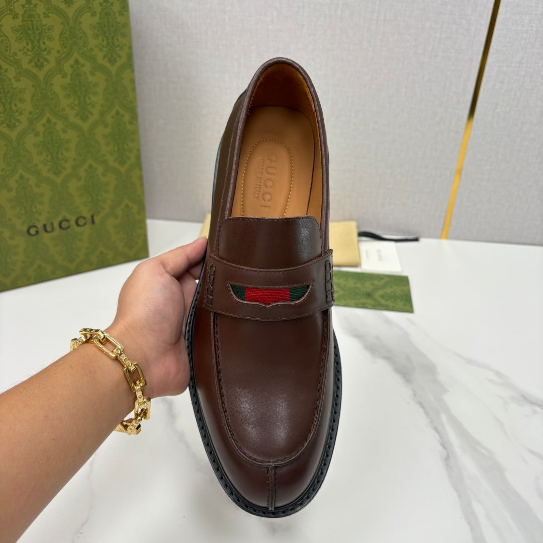 Gucci unisex leather loafer front view, dark brown with green-red stripe across moc toe