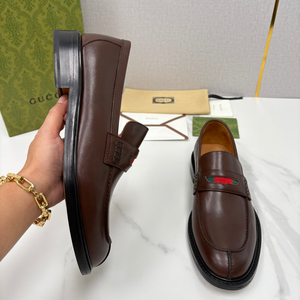 Gucci unisex leather loafer side view, dark brown slip-on with buckle strap and green-red stripe