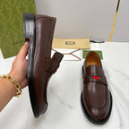 Gucci unisex leather loafer side view, dark brown slip-on with buckle strap and green-red stripe