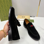 Gucci unisex black suede loafers with side buckle strap and multicolor stripe.