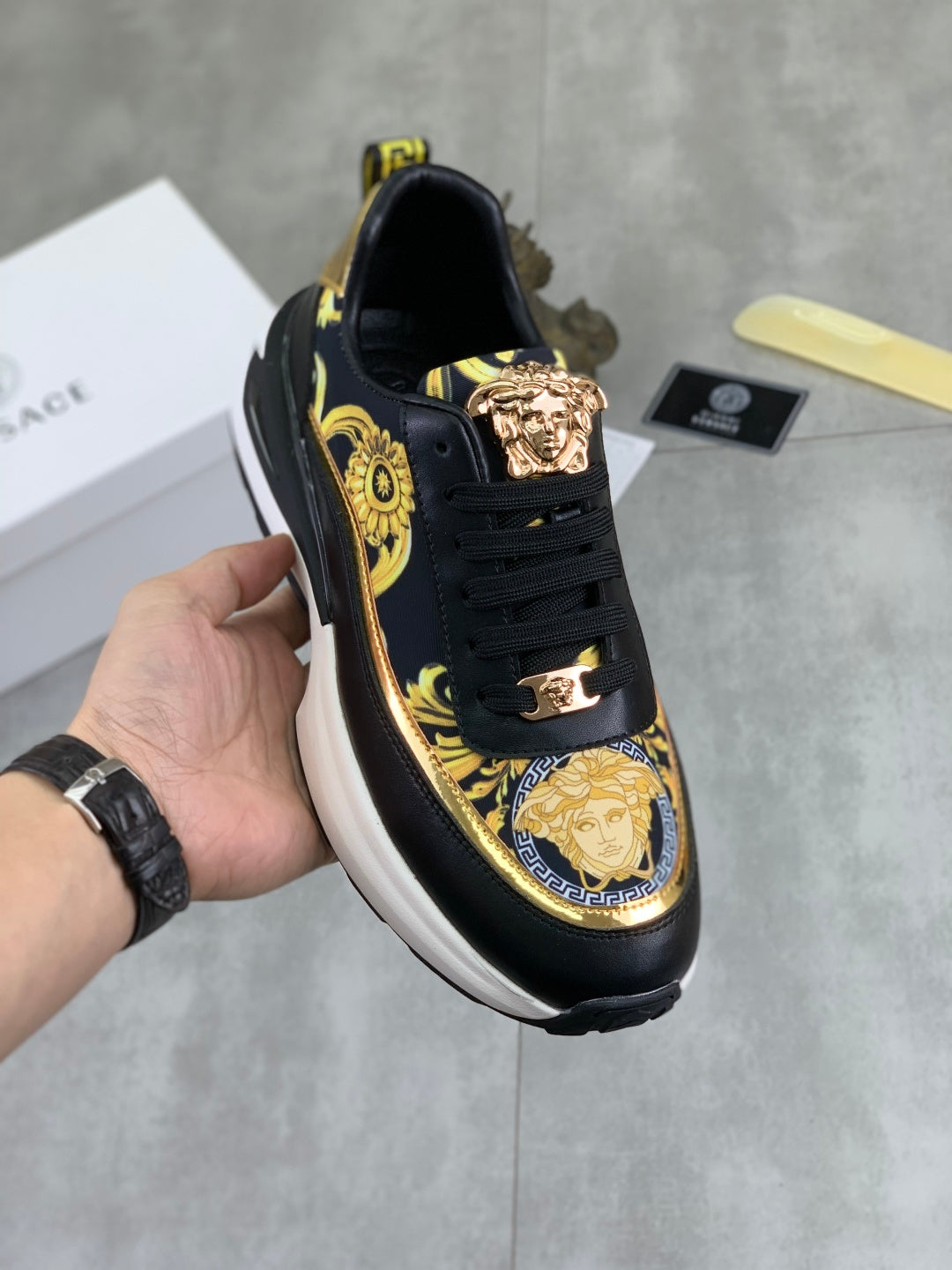 Versace low-top sneakers, black with gold baroque print, gold buckle detail, white sole