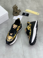 Versace low-top sneakers in black with gold ornate print and chunky white platform sole
