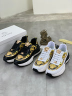 Versace sneaker pair: black-and-gold design and white-and-gold design with Versace crest