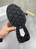 Versace sneaker outsole with dark tread pattern and textured traction grooves