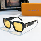 Black sunglasses with yellow-tinted lenses and LV logo on temple