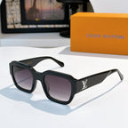 Black sunglasses with purple-tinted lenses and LV logo on temple