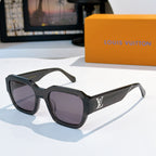 Black sunglasses with purple-tinted lenses and LV logo on temple